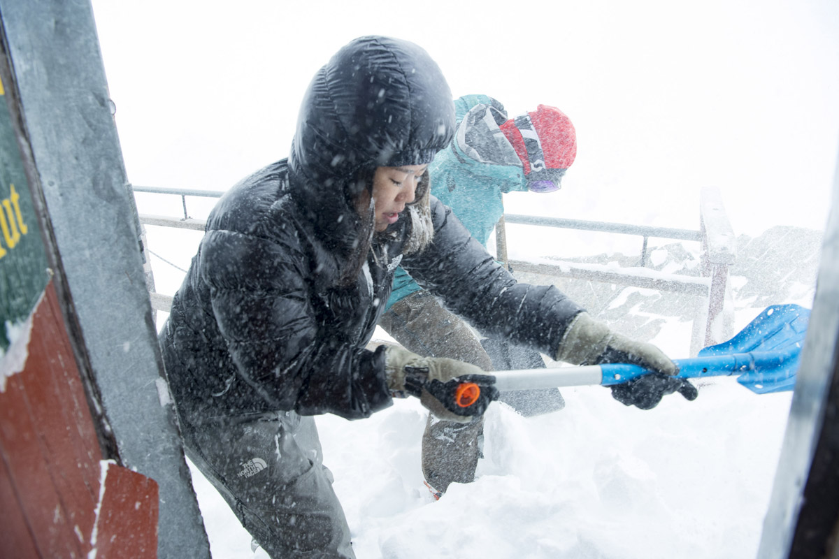 Janina and Ayako clearing snow from Kelman Hut, photo by Mark Watson
